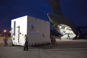 Tucked into a shipping container, NASA's OSIRIS-REx spacecraft is unloaded from an Air Force C-17 cargo aircraft on the Shuttle Landing Facility runway at Kennedy Space Center in Florida. The spacecraft traveled from Lockheed Martin's facility near Denver to Kennedy to begin processing for its upcoming launch. (Photo: Bill White) Tucked into a shipping container, NASA's OSIRIS-REx spacecraft is unloaded from an Air Force C-17 cargo aircraft on the Shuttle Landing Facility runway at Kennedy Space Center in Florida. The spacecraft traveled from Lockheed Martin's facility near Denver to Kennedy to begin processing for its upcoming launch. (Photo: Bill White)
